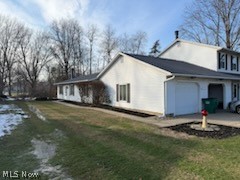 97 Park Road Painesville, OH 44077 - Photo 3 of 18 View of home's exterior featuring a yard and an attached garage
