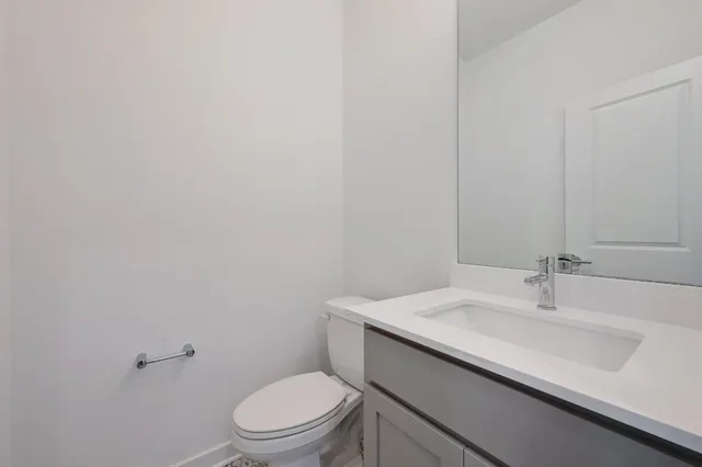 a bathroom with a sink toilet and vanity