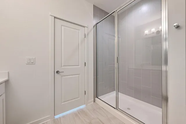 a bathroom with a glass shower door