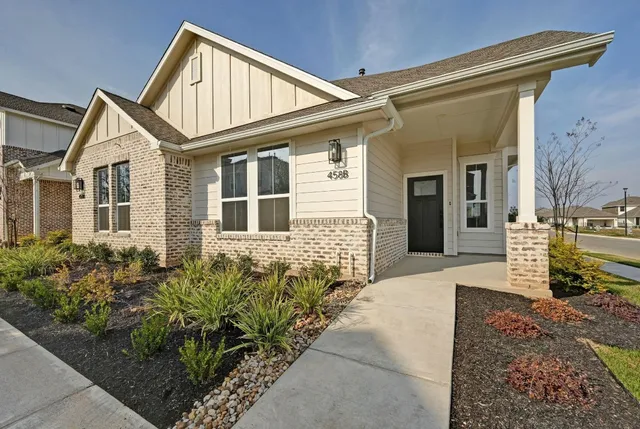 a front view of a house with garden
