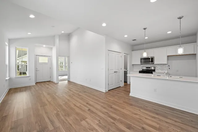 a view of kitchen with sink and refrigerator
