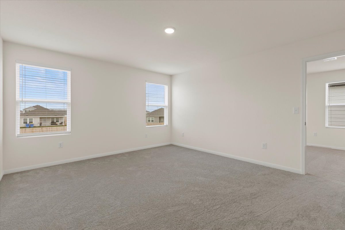 113 Rother Place Taylor, TX 76574 - Photo 13 of 34 Spare room featuring plenty of natural light, light carpet, and recessed lighting