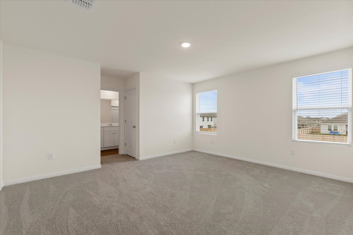113 Rother Place Taylor, TX 76574 - Photo 14 of 34 Unfurnished bedroom with light colored carpet, ensuite bathroom, and recessed lighting