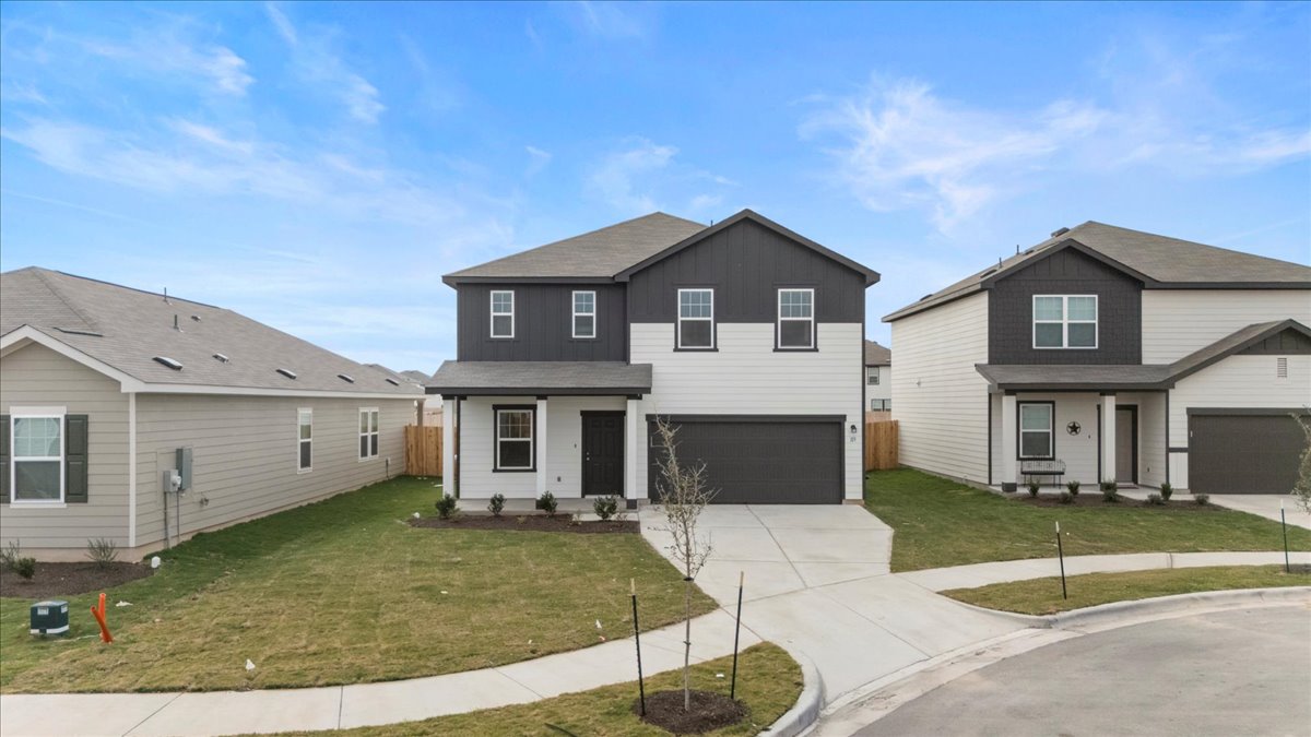 113 Rother Place Taylor, TX 76574 - Photo 2 of 34 View of front of house with a front lawn, concrete driveway, an attached garage, and a porch