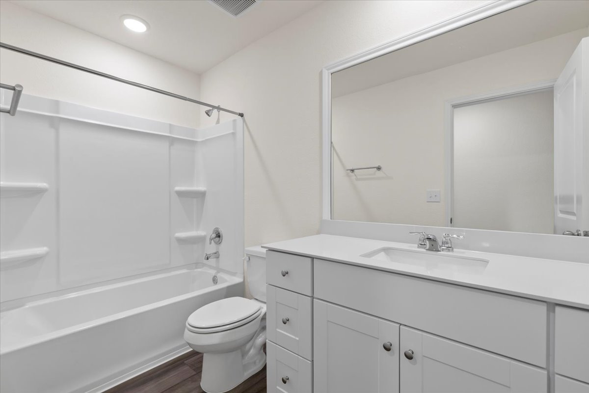 113 Rother Place Taylor, TX 76574 - Photo 23 of 34 Bathroom with shower / washtub combination, vanity, and dark wood-type flooring