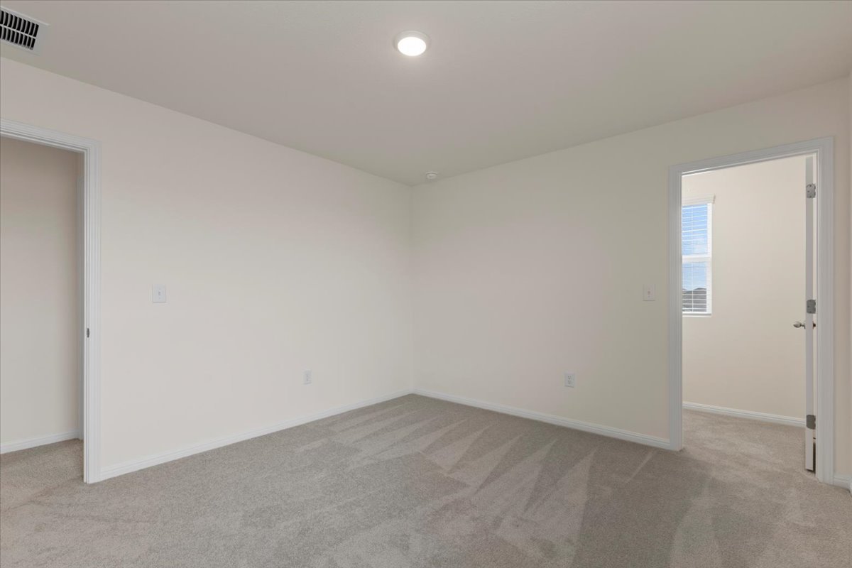 113 Rother Place Taylor, TX 76574 - Photo 25 of 34 Spare room with baseboards and light colored carpet