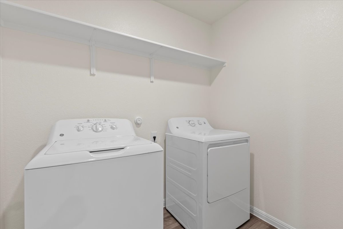 113 Rother Place Taylor, TX 76574 - Photo 27 of 34 Laundry room with washer and dryer and wood finished floors