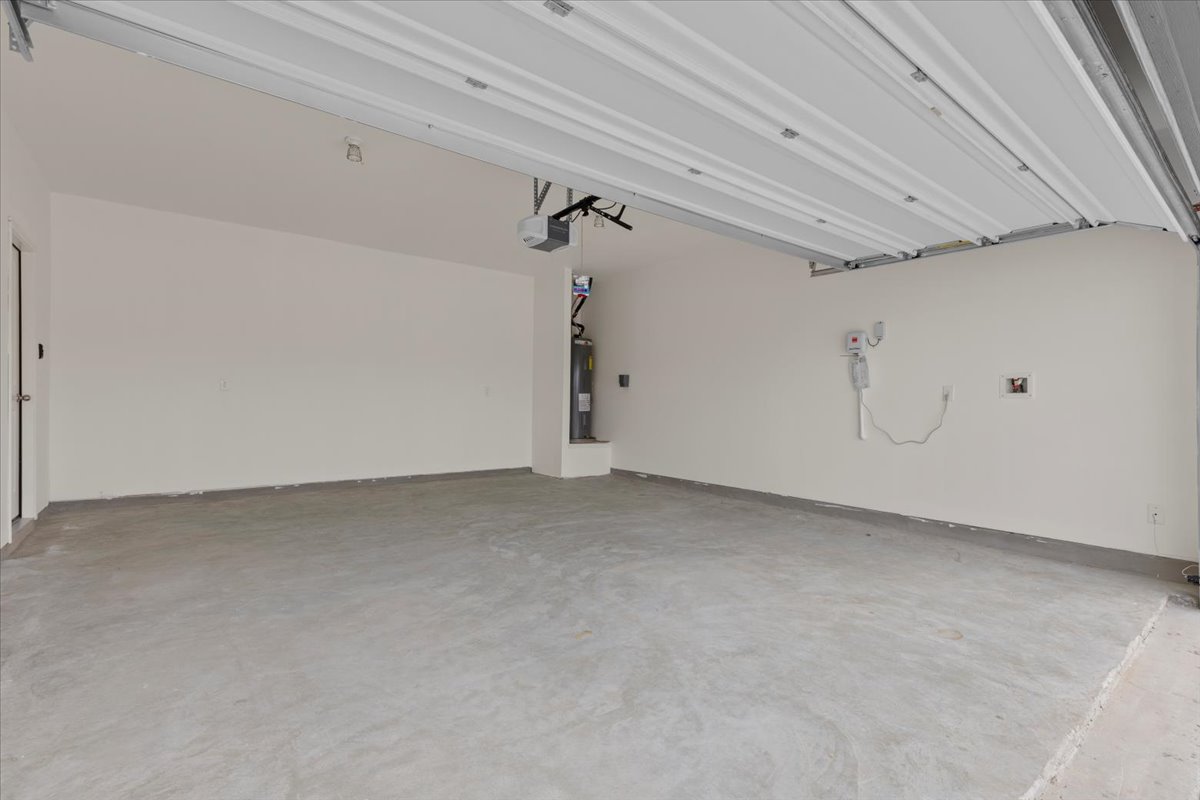 113 Rother Place Taylor, TX 76574 - Photo 28 of 34 Garage with electric water heater