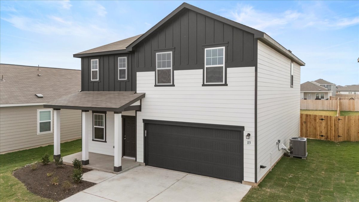 113 Rother Place Taylor, TX 76574 - Photo 4 of 34 View of front of home featuring board and batten siding, a garage, covered porch, driveway, and roof with shingles