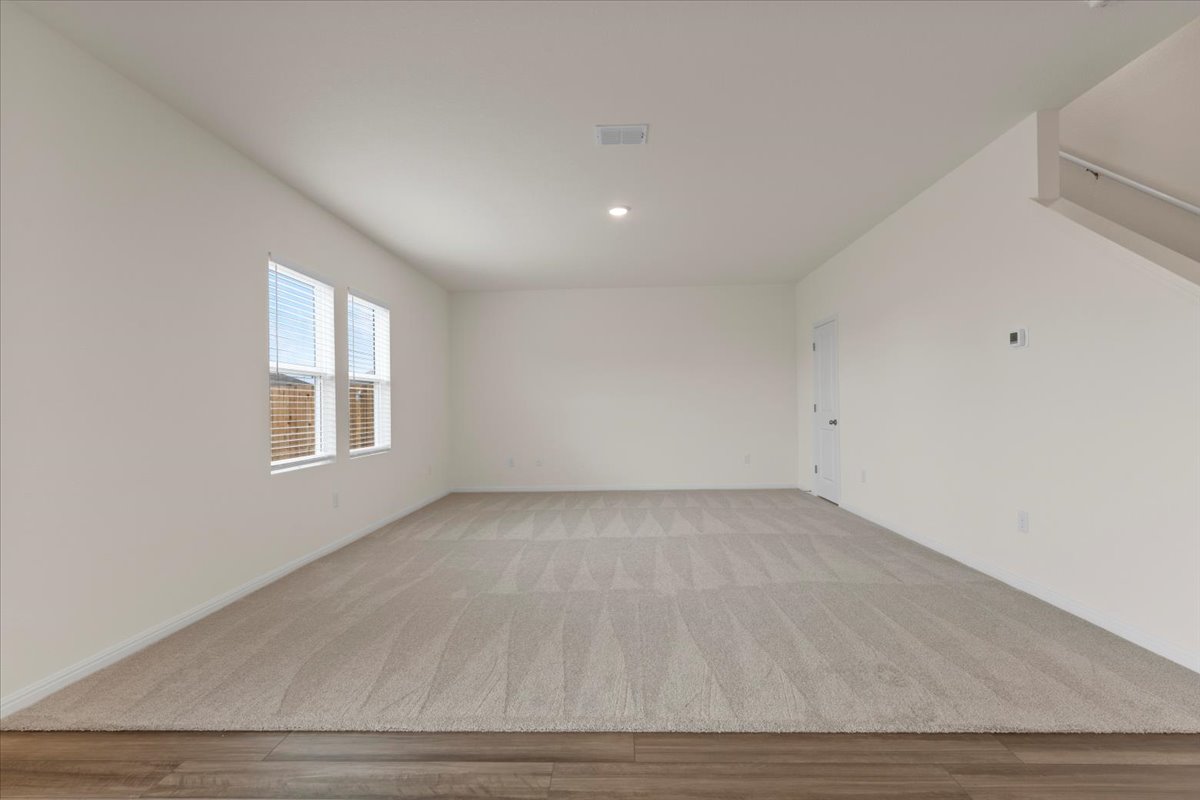 113 Rother Place Taylor, TX 76574 - Photo 7 of 34 Spare room with wood finished floors and recessed lighting