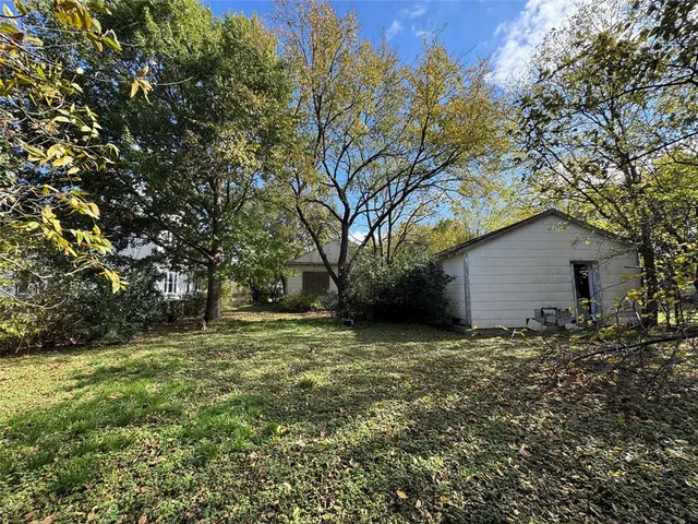 a backyard of a house with large trees