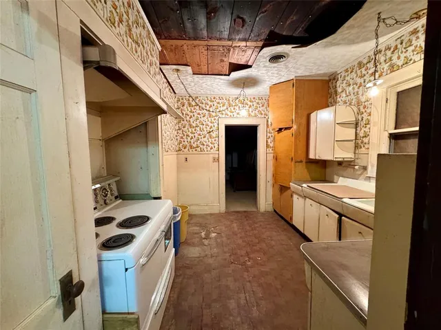 a kitchen with stainless steel appliances granite countertop a stove and a refrigerator