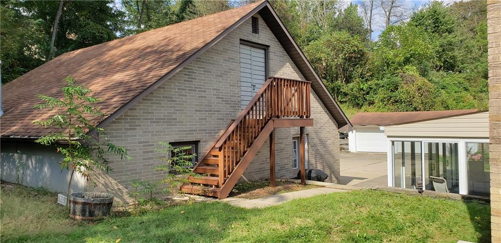148 Morgan Hill Road Cuddy, PA 15031 - Photo 25 of 25 A view of the garage with two side access doors. The steps lead to extra storage above the two car detached garage for all your extras. And take a glimpse of the flat side yard, a perfect size for a small swing set for kids, play area for animals or plant a garden!