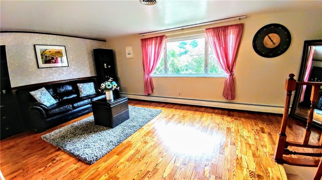 148 Morgan Hill Road Cuddy, PA 15031 - Photo 7 of 25 Come take seat on the couch and relax in this beautiful room on the main level. This large window lets in the beautiful sun keeping life feeling cheery.