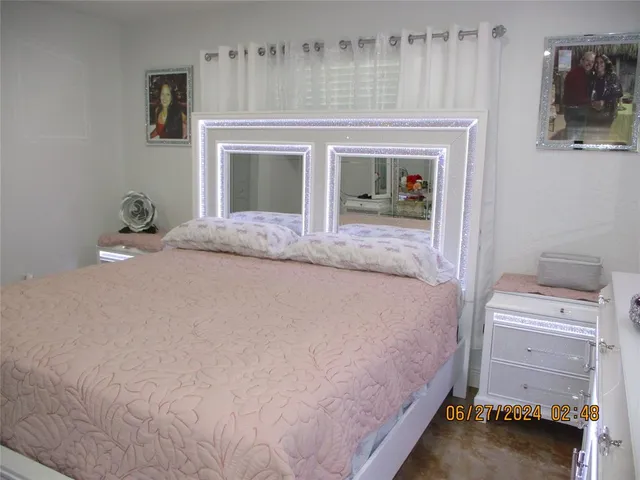 a bedroom with a bed and a fireplace