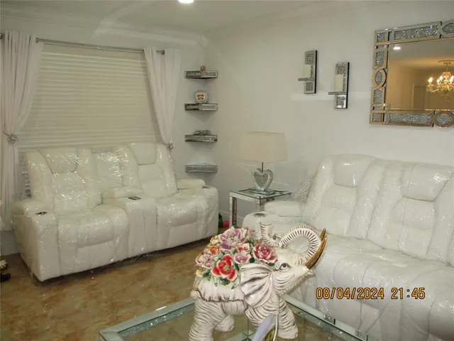 a living room with furniture and flowers