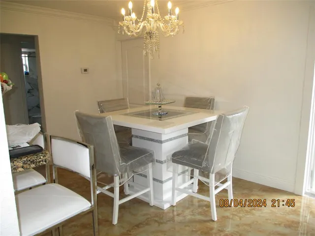 a view of a dining room with furniture and chandelier