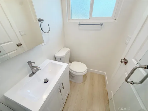 a bathroom with a sink a toilet and shower