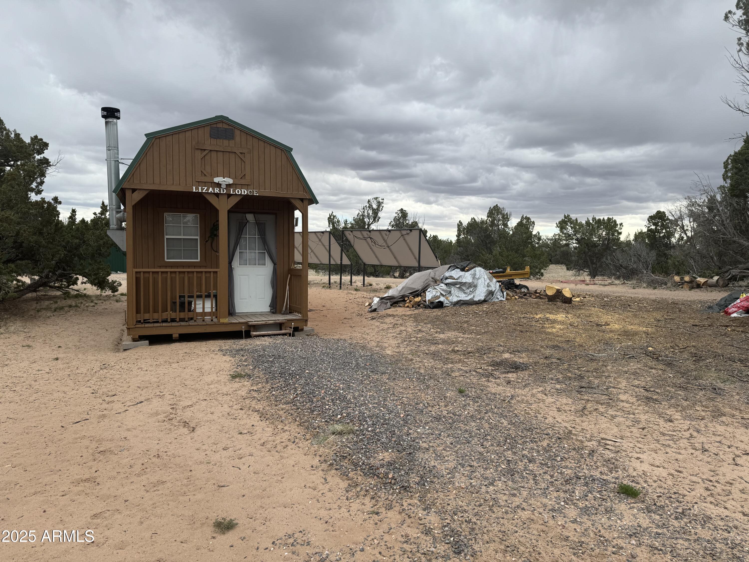 Lot 64 Sierra Mountain Ranch, Unit 64 St. Johns, AZ 85936 - Photo 27 of 38 a view of a tiny house with a yard