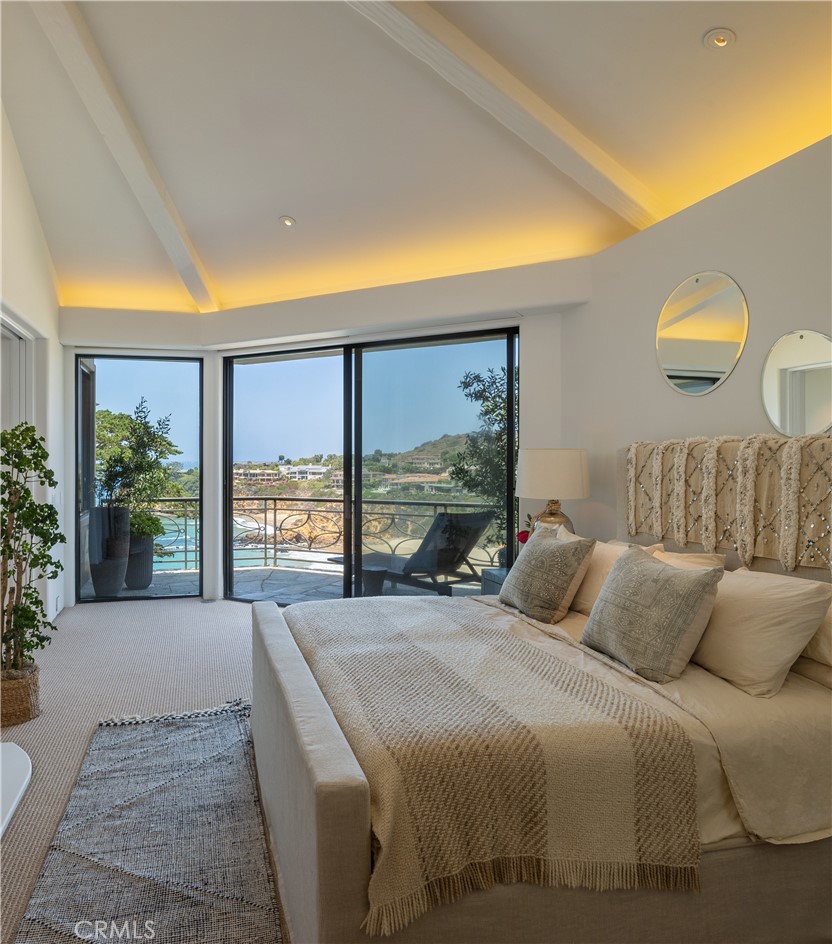 199 Emerald Bay Laguna Beach, CA 92651 - Photo 17 of 23 a bedroom with a large bed and a large window