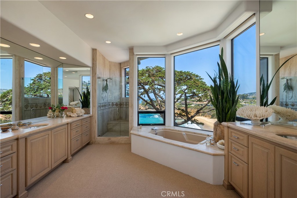 199 Emerald Bay Laguna Beach, CA 92651 - Photo 18 of 23 a large white bathroom with a large tub and sink