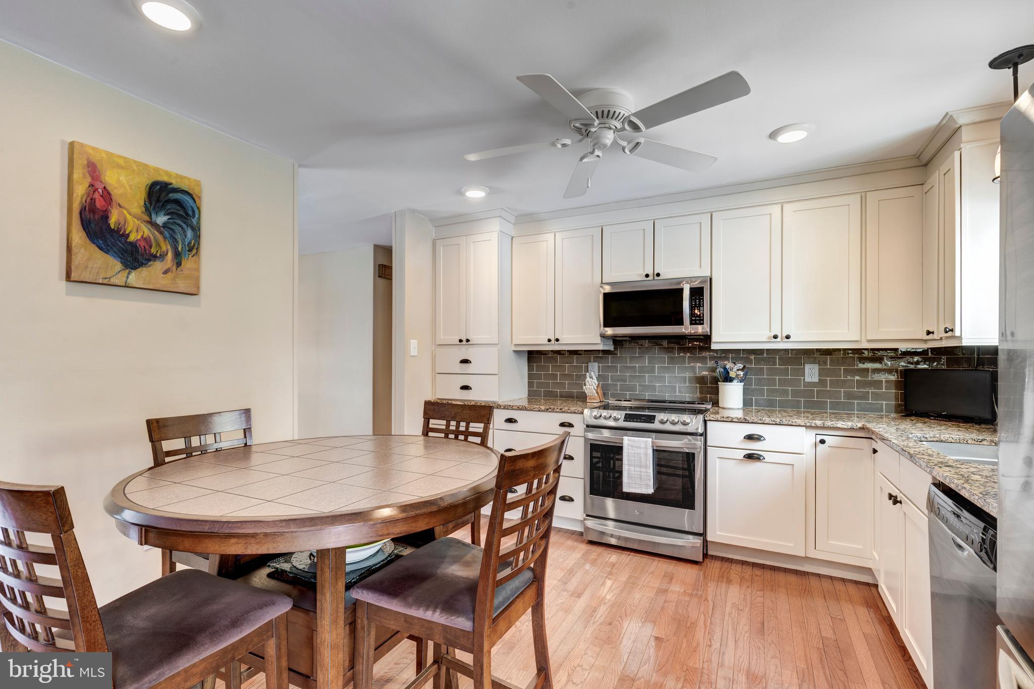 4316 Utz Road Hampstead, MD 21074 - Photo 13 of 82 a kitchen with stainless steel appliances a white table and chairs