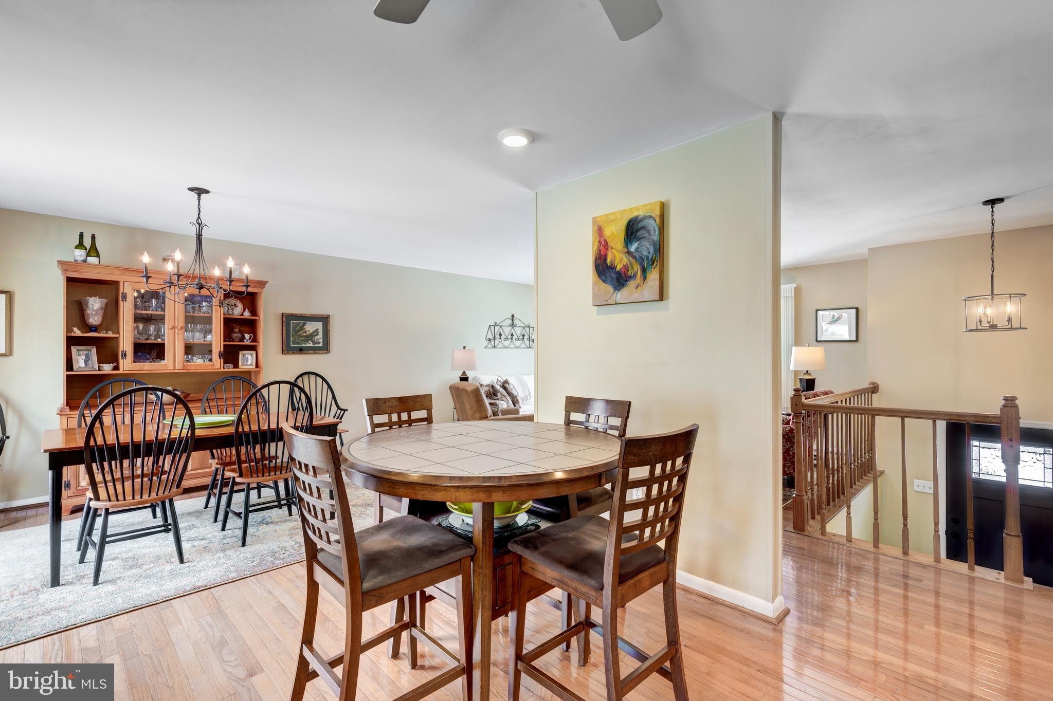 4316 Utz Road Hampstead, MD 21074 - Photo 14 of 82 a view of a dining room and livingroom with furniture wooden floor a rug a painting and a chandelier