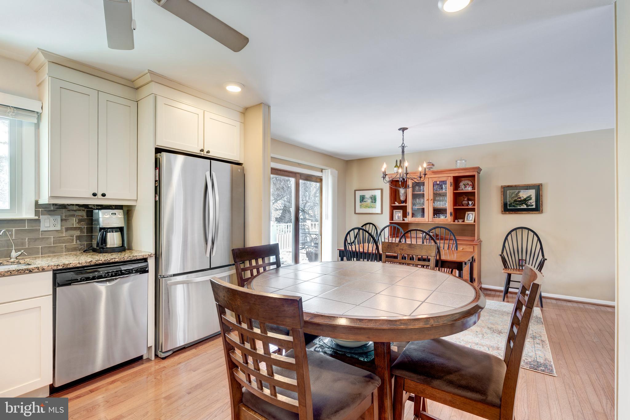 4316 Utz Road Hampstead, MD 21074 - Photo 15 of 82 a kitchen with stainless steel appliances a dining table chairs and refrigerator