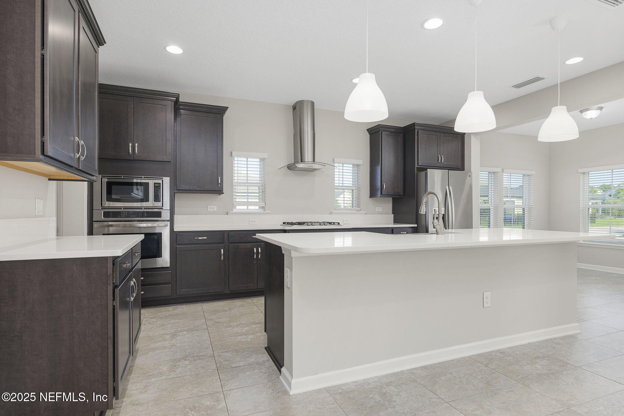 299 Clarys Run St. Augustine, FL 32092 - Photo 11 of 39 a kitchen with kitchen island granite countertop a sink counter top space appliances and cabinets