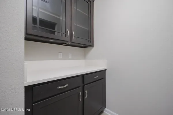 an empty room with white walls and entrance
