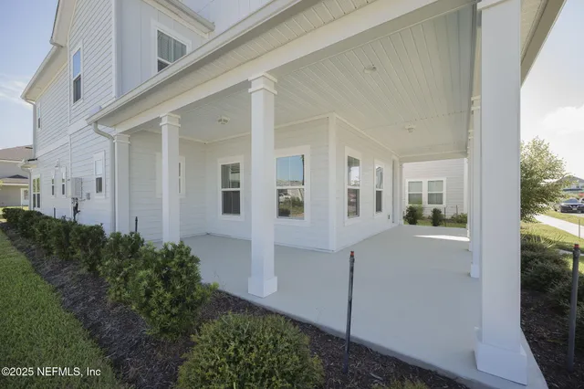 a view of a hallway with bathroom and front door