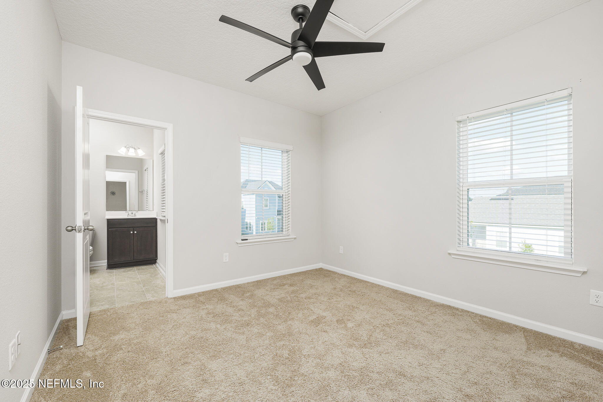 299 Clarys Run St. Augustine, FL 32092 - Photo 25 of 39 an empty room with windows and a ceiling fan