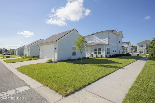 an aerial view of residential houses with outdoor space