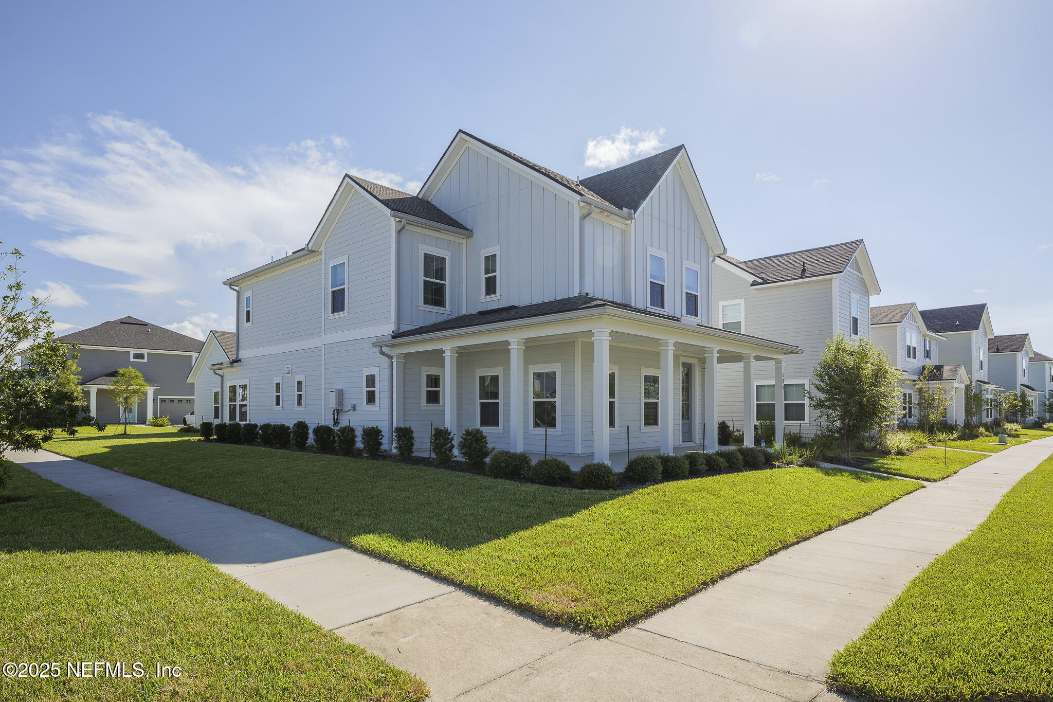 299 Clarys Run St. Augustine, FL 32092 - Photo 35 of 39 a view of a white house next to a yard with big trees