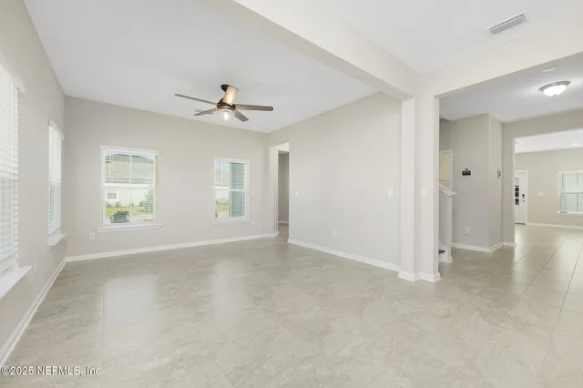a view of a hallway with entryway and stairs