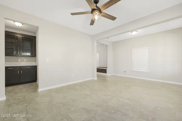 a view of kitchen with kitchen island a sink stainless steel appliances and cabinets