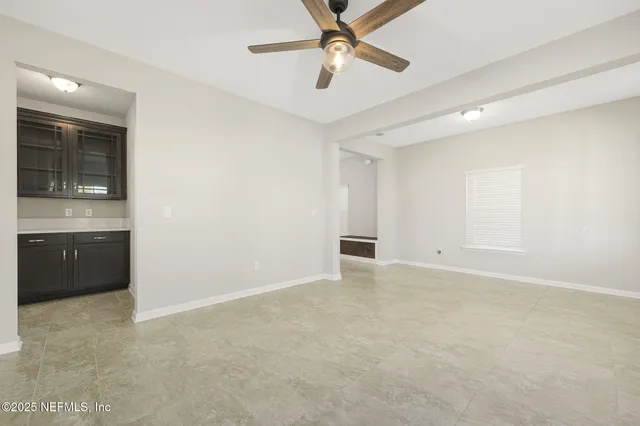 a view of kitchen with kitchen island a sink stainless steel appliances and cabinets
