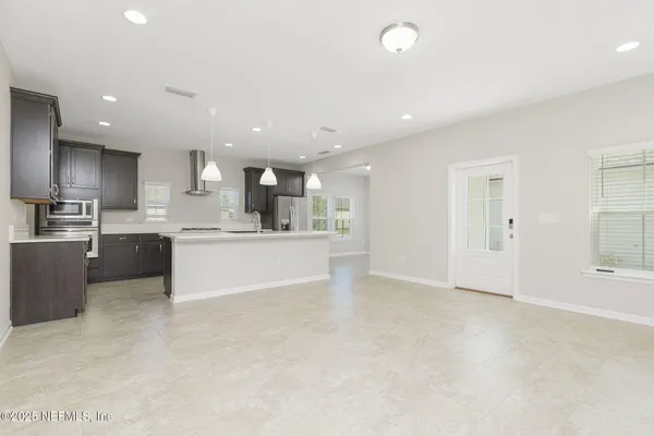 an empty room with windows and closet