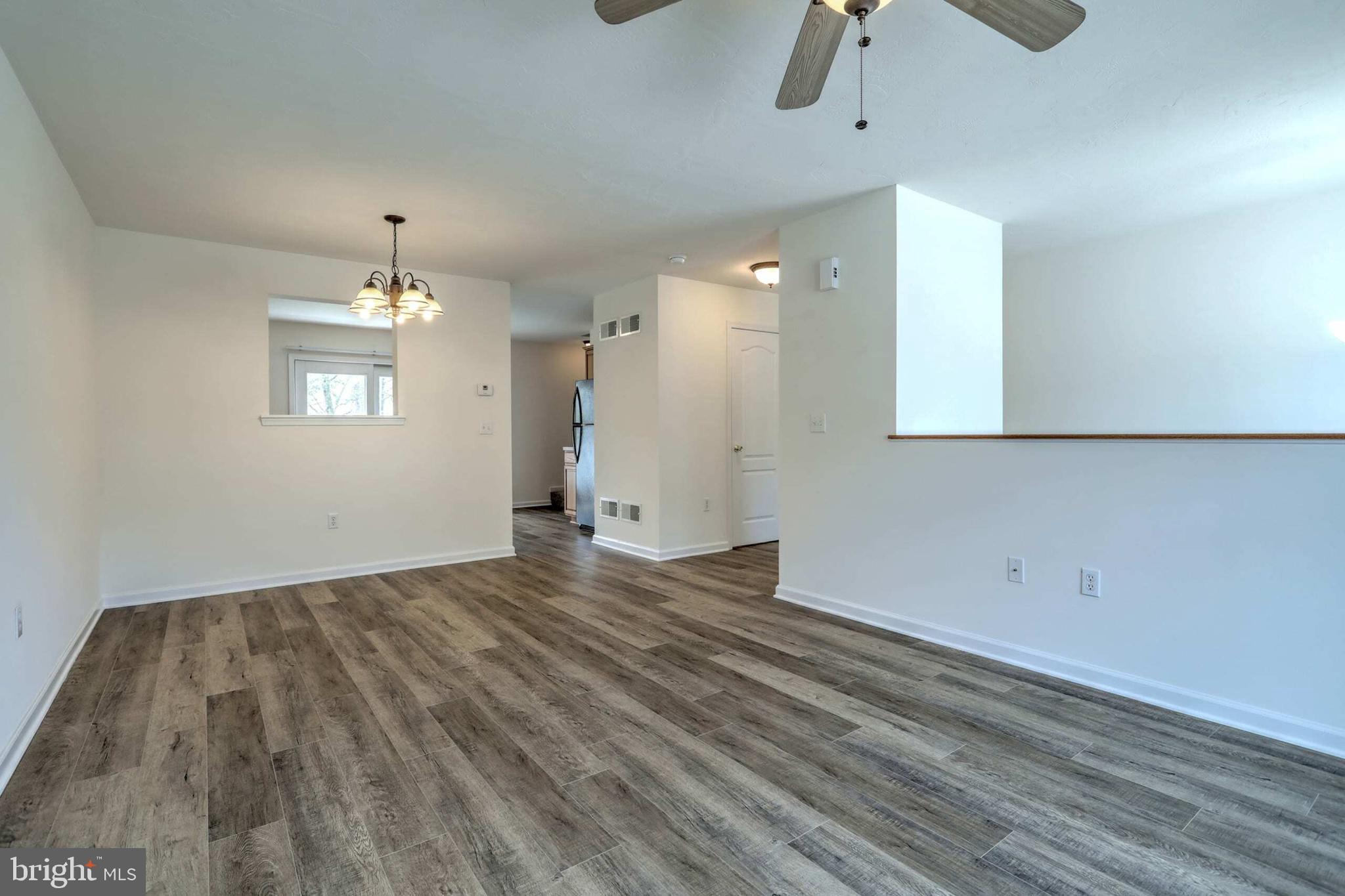18 Grace Avenue Hanover, PA 17331 - Photo 14 of 15 an empty room with wooden floor chandelier fan and windows
