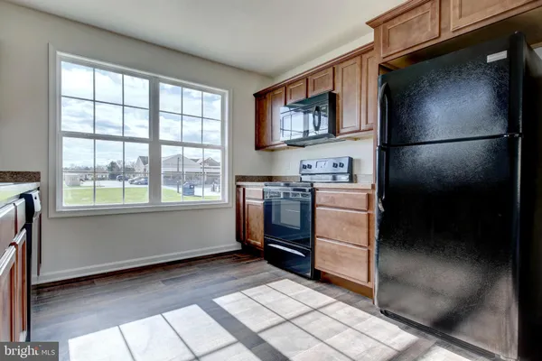 a kitchen with a refrigerator and a stove