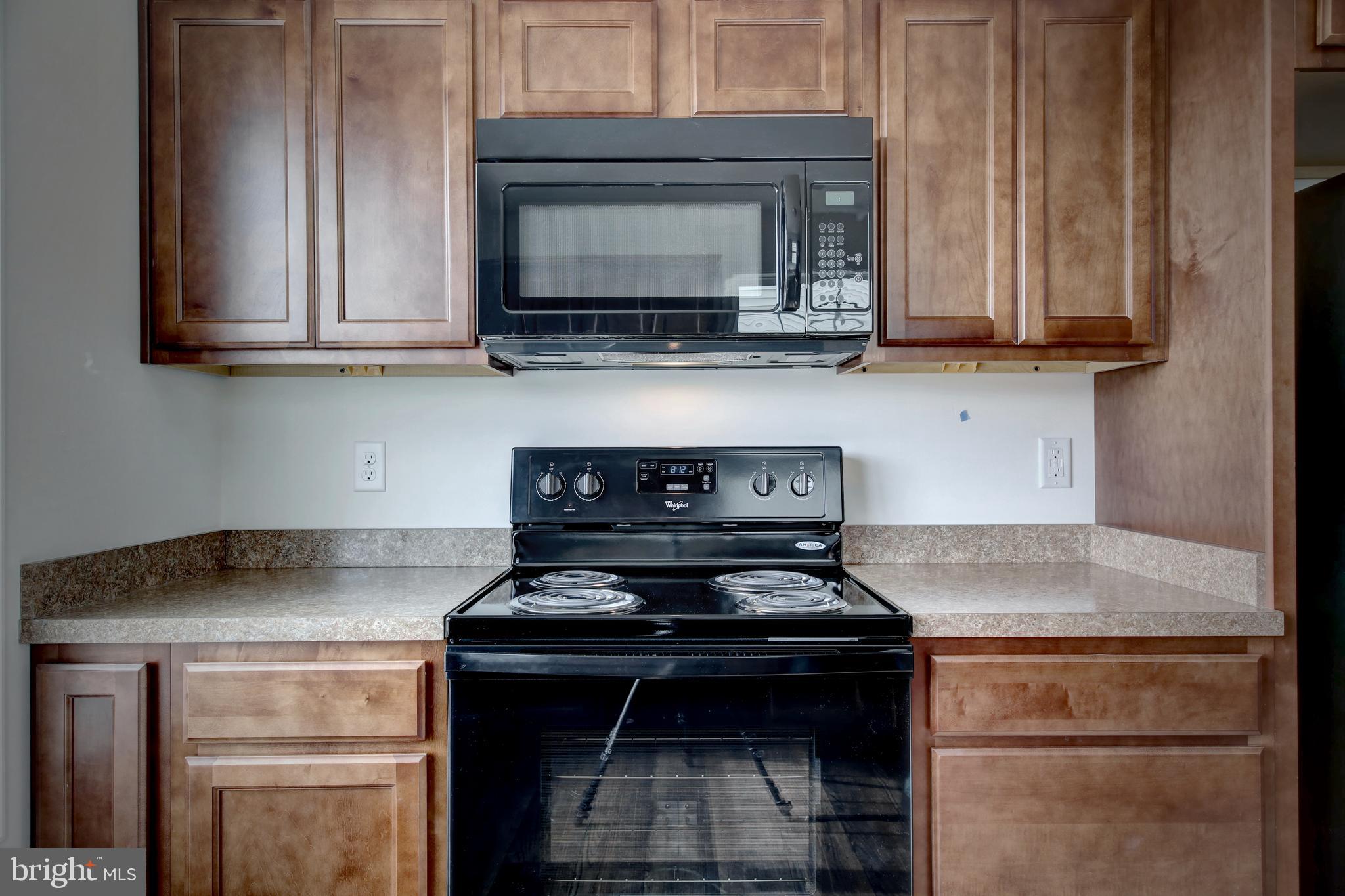 18 Grace Avenue Hanover, PA 17331 - Photo 7 of 15 a kitchen with stainless steel appliances granite countertop a stove and a microwave