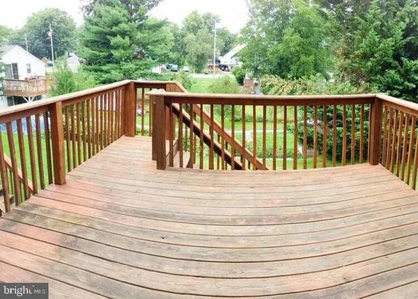 a view of balcony with wooden floor and fence