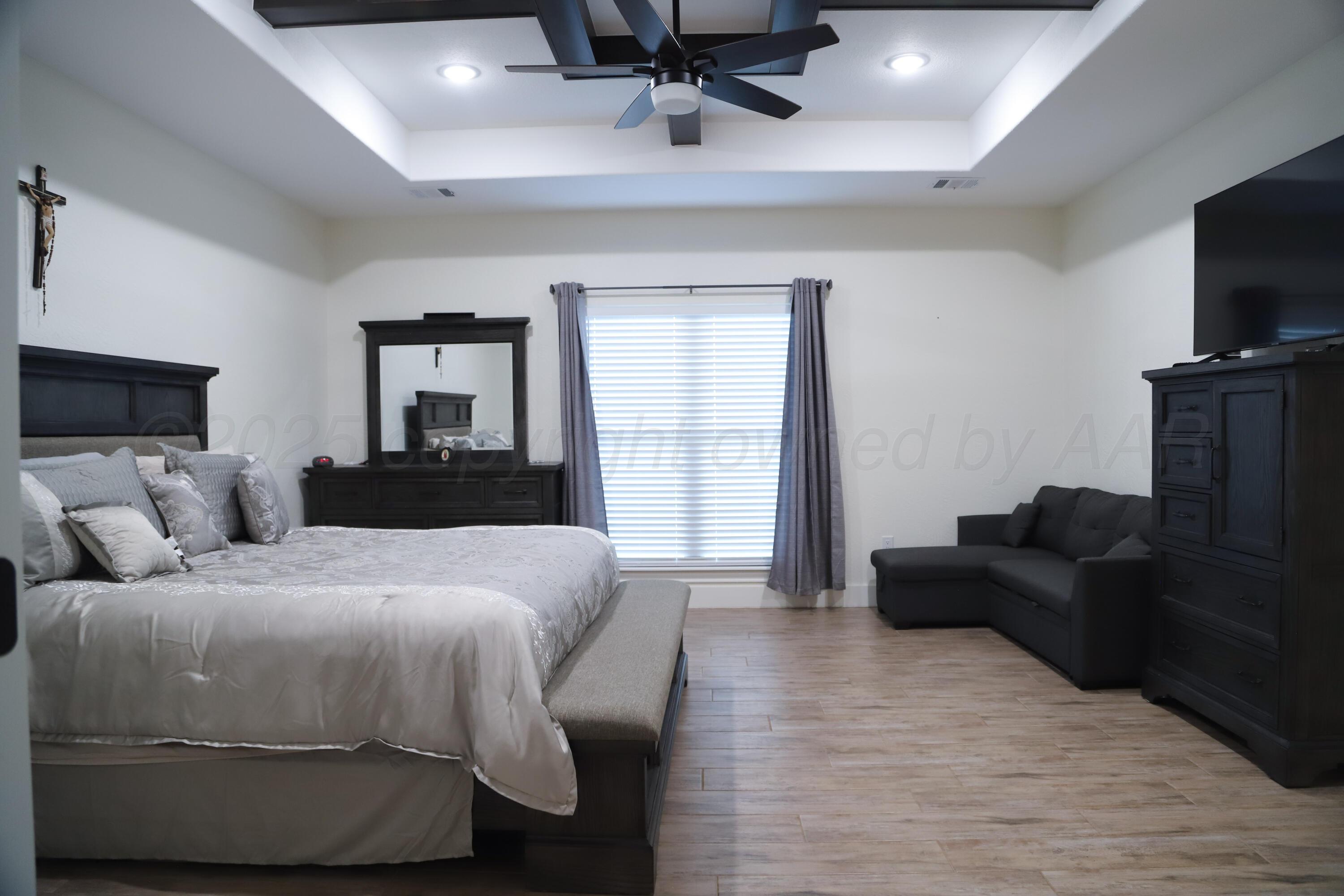 11501 Cutter Lane Amarillo, TX 79118 - Photo 11 of 24 a bedroom with a bed and a flat screen tv