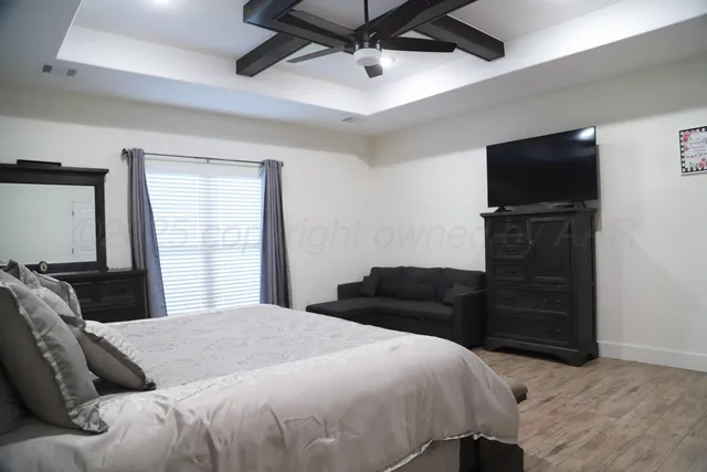 a bedroom with a bed and a television