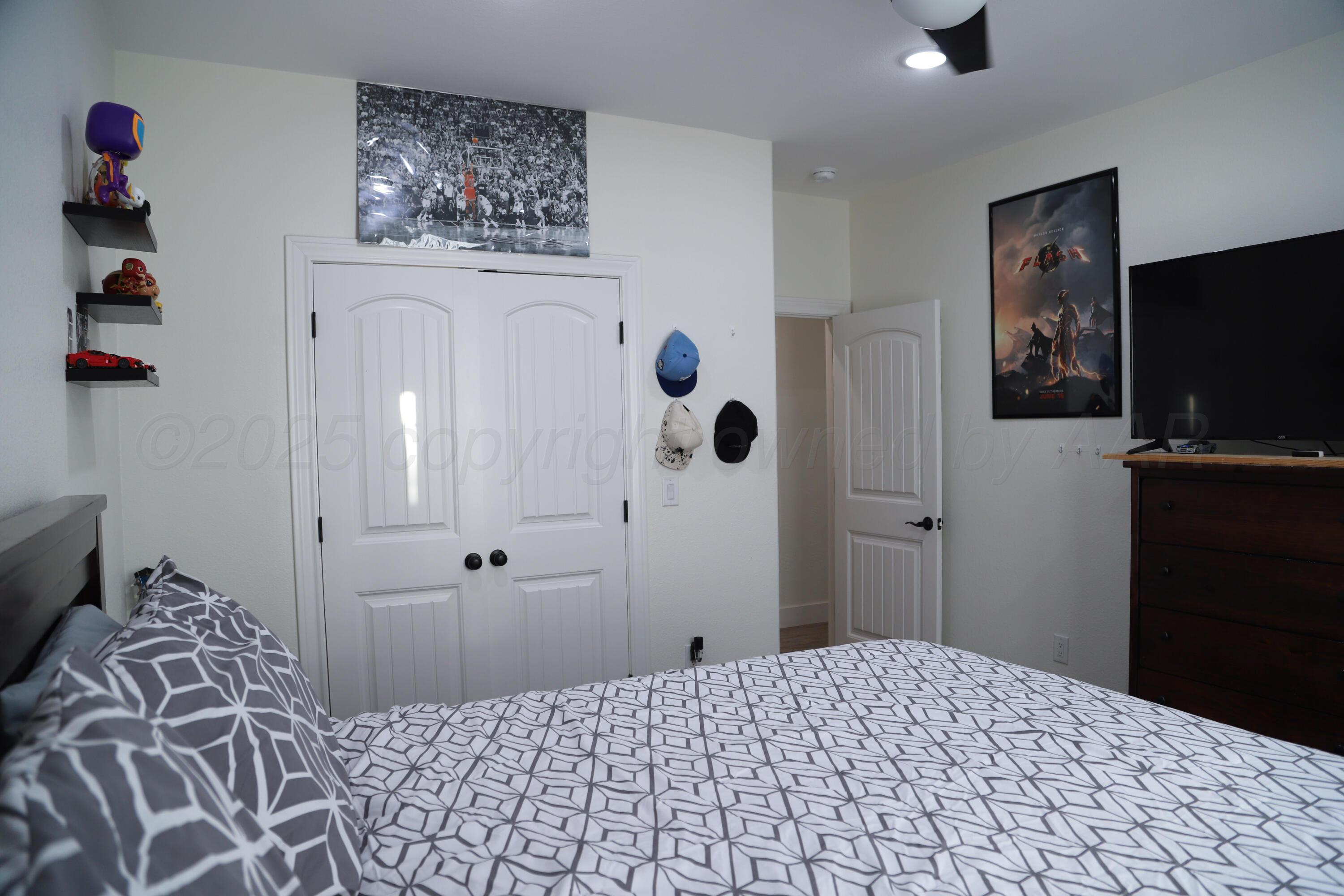 11501 Cutter Lane Amarillo, TX 79118 - Photo 20 of 24 a bedroom with a bed and a television