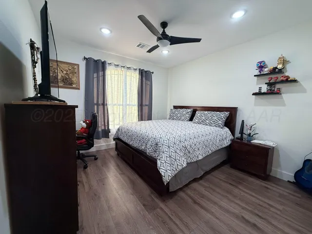 a bedroom with a bed dresser and a window