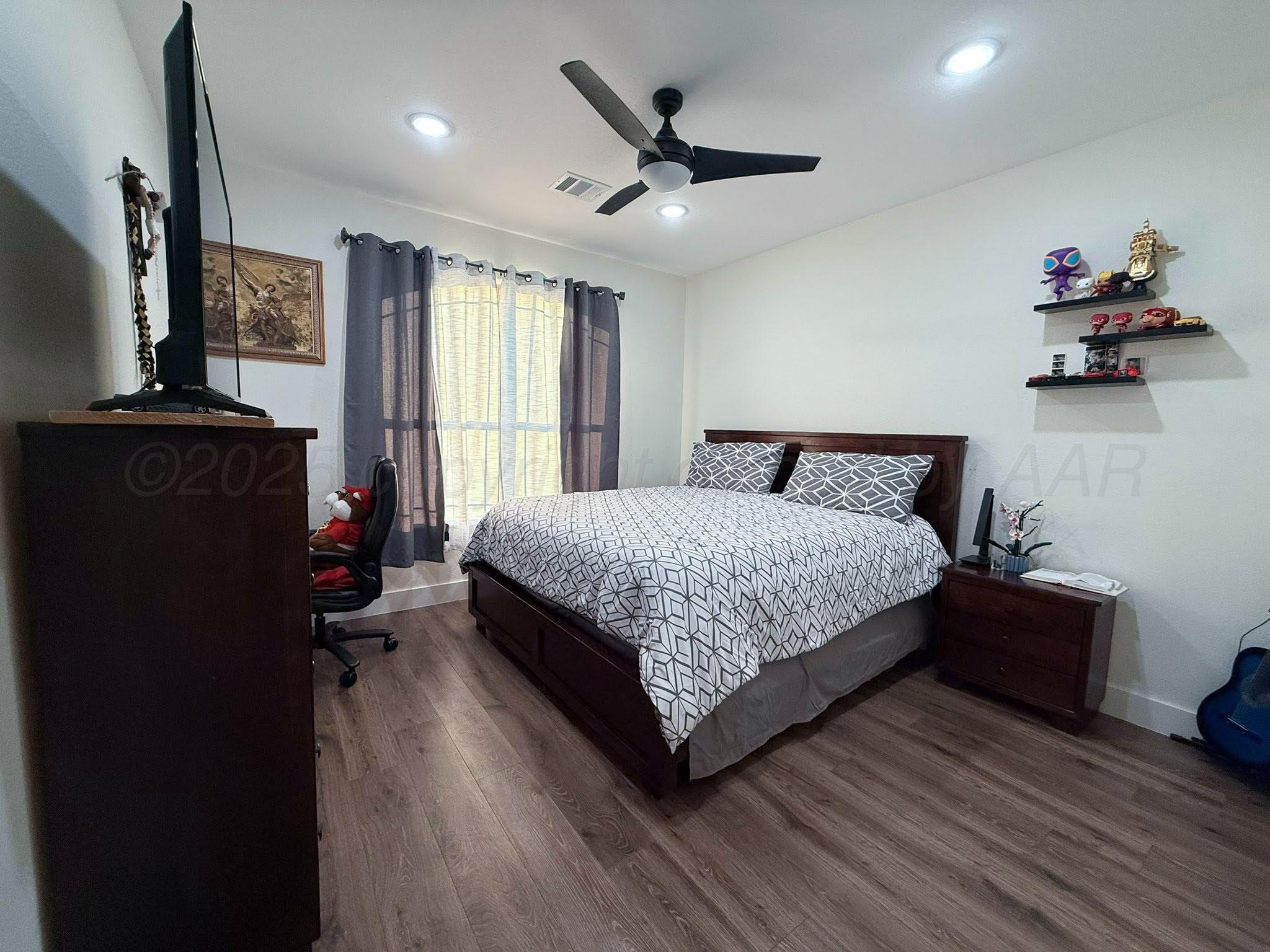 11501 Cutter Lane Amarillo, TX 79118 - Photo 21 of 24 a bedroom with a bed dresser and a window