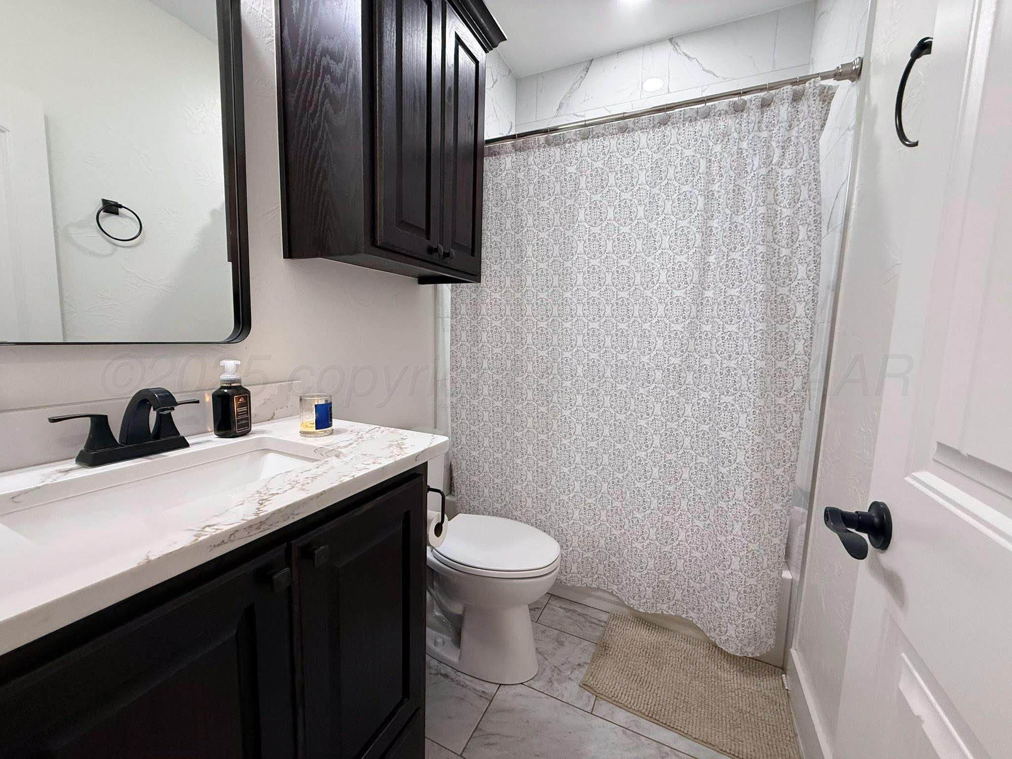 11501 Cutter Lane Amarillo, TX 79118 - Photo 23 of 24 a bathroom with a granite countertop sink toilet and shower