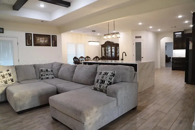 a living room with furniture and kitchen view