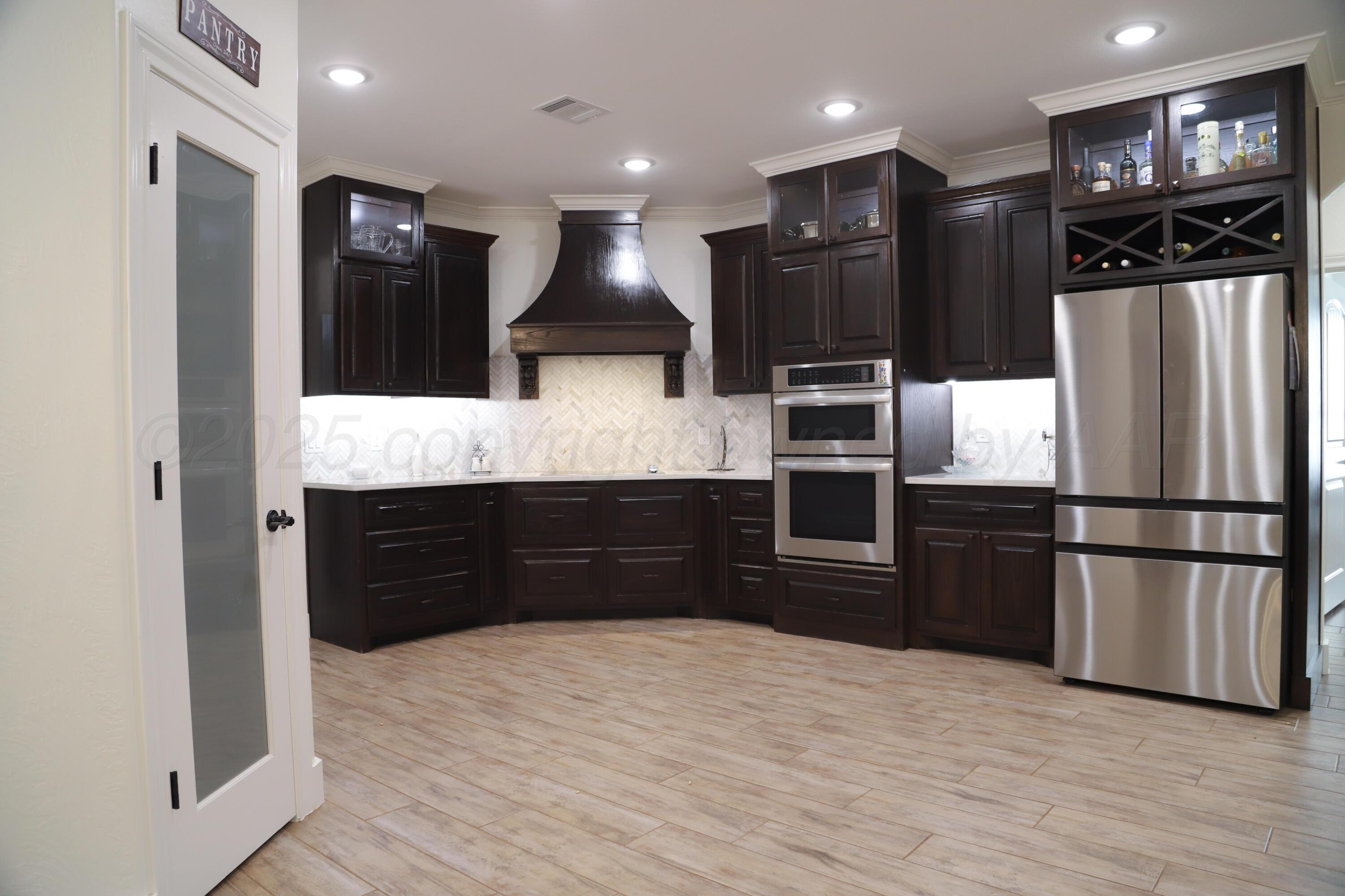 11501 Cutter Lane Amarillo, TX 79118 - Photo 5 of 24 a kitchen with stainless steel appliances granite countertop a refrigerator and a sink